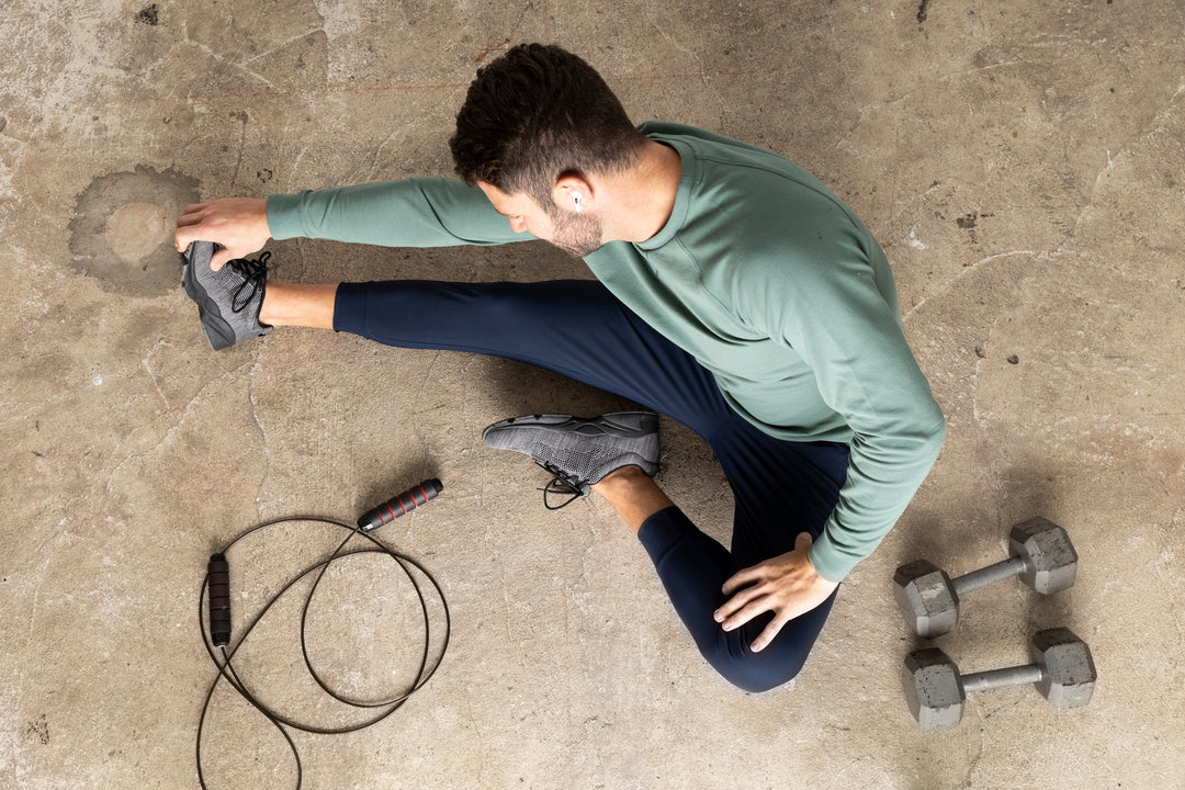 Model stretching wearing Sweatshirt and Hybrid Joggers.